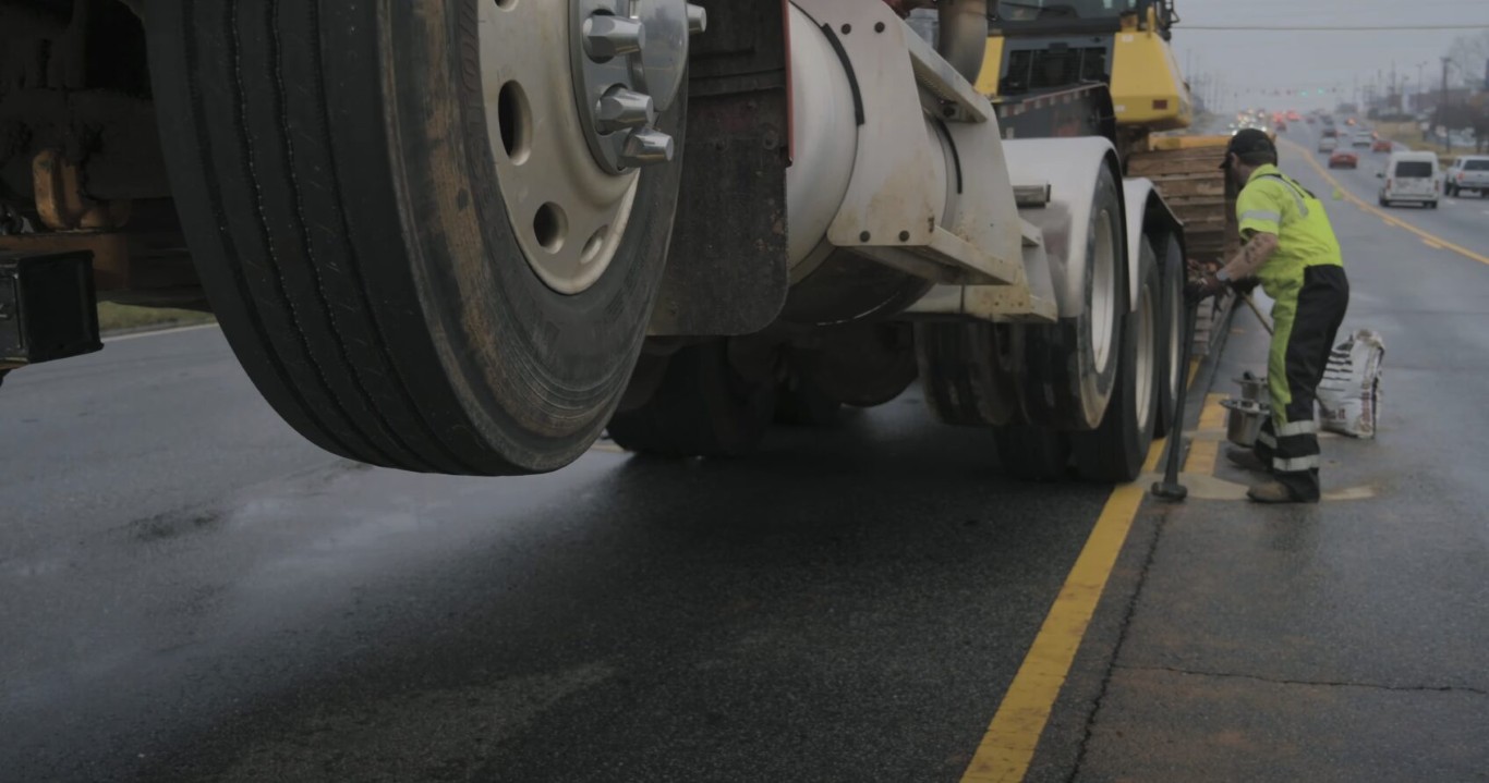Roadside assistance technician helping stranded driver in Poway